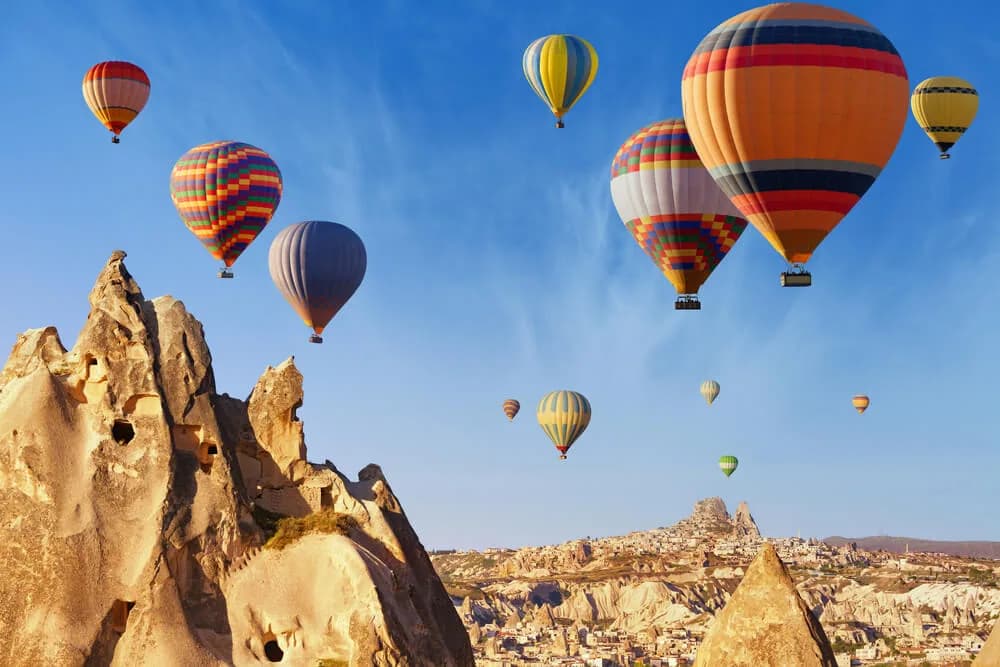 Hot air balloons flying over Cappadocia at sunrise